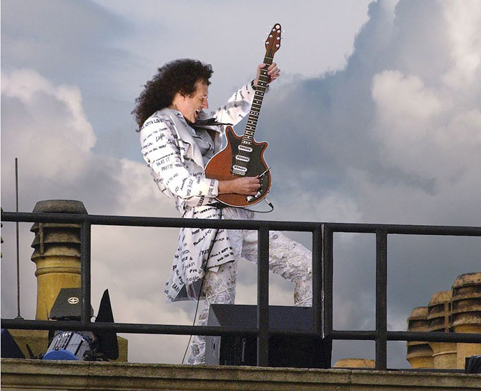 Brian May playing guitar on Buckingham Palace roof
