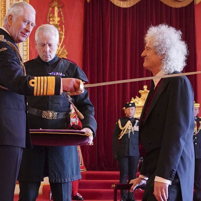 HM King Charles III bestows the honor of Knight Bachelor upon Sir Brian May at Buckingham Palace in 2023