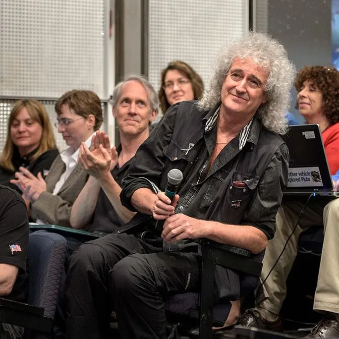 Astrophysicist Dr. Brian May is recognized during a July 17, 2015 New Horizons science briefing at NASA Headquarters