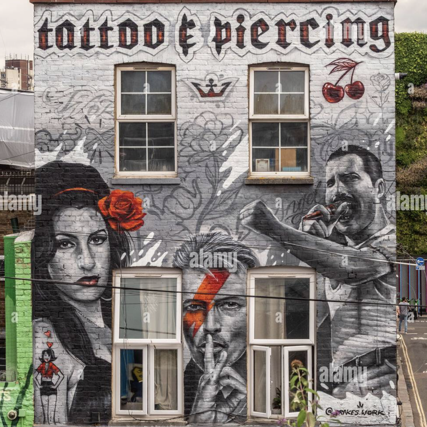 Mural depicting music legends Amy Winehouse, David Bowie, and Freddie Mercury on a building in Camden Town, London, UK